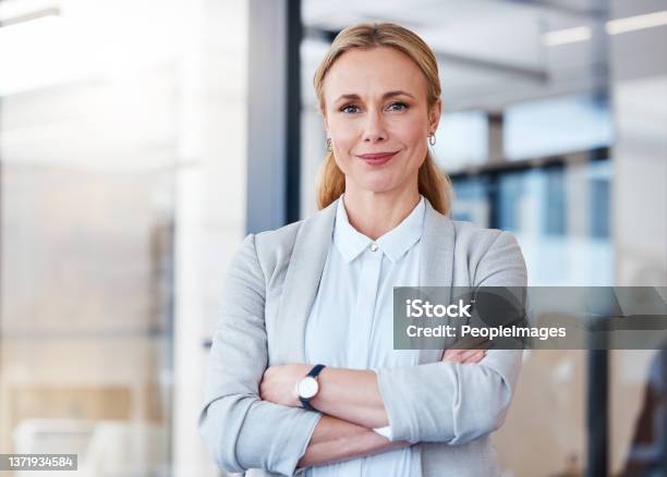 Portrait Of A Confident Mature Businesswoman Working In A Modern Office Stock Photo - Download Image Now