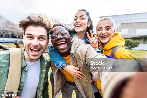 Multiracial Students Company Taking Selfie Portrait In University Campus Multi Ethnic Best Friends Laughing At Camera Outside Teens Having Fun Together Youth Culture And School Concept Stock Photo - Download Image Now