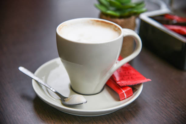 istock Coffee with cream. White porcelain coffee cup with plate. 1371935127