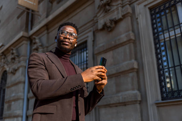istock Businessman using phone in the city 1371936109