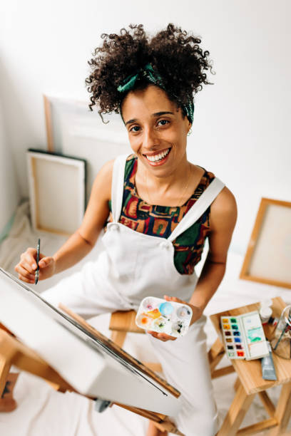 istock Confident young female painter drawing on a canvas 1371937934
