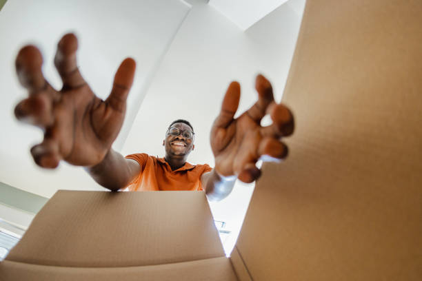 istock Smiling man unpacking things out of box 1371937950