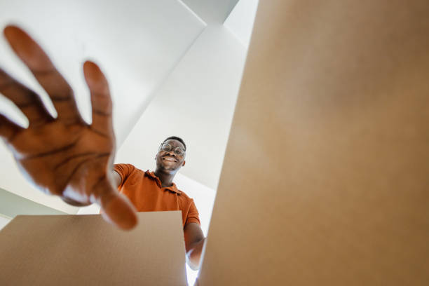 istock Smiling man unpacking things out of box 1371938023