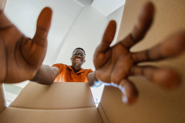 istock Smiling man unpacking things out of box 1371938025