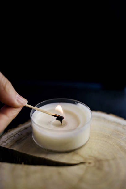 istock girl lights a candle 1371938744