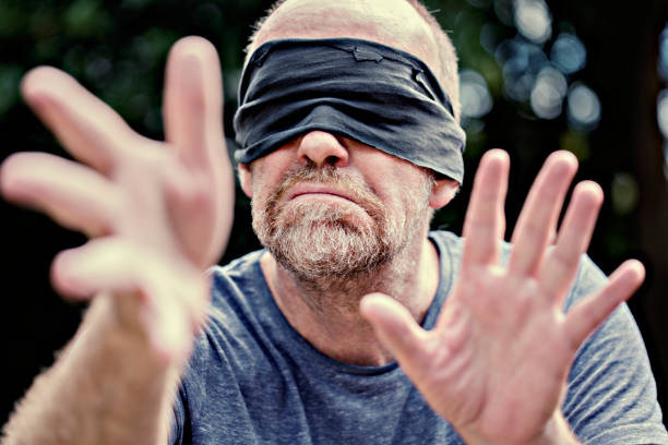 Blind fold A man with a blind fold over his eyes red blindfold stock pictures, royalty-free photos & images