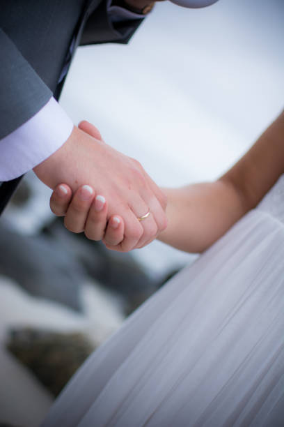 istock Holding hands newlyweds 1371940804