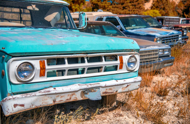 Rusty old cars under a blue sky. Old vintage vehicles.