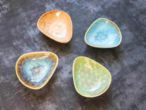 istock 4 ceramic saucers in different colors on dark background 1371942830