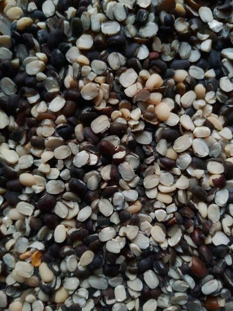 istock Close up of split black lentil (urad dal)  with shell filled in as background 1371942893