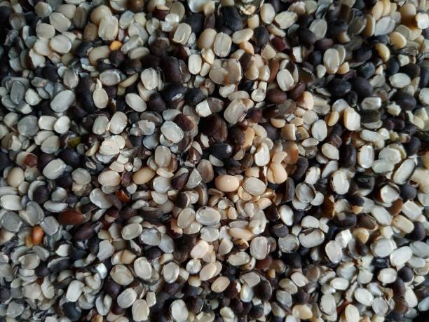 istock Close up of split black lentil (urad dal)  with shell filled in as background 1371942895