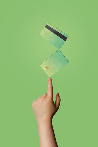 istock Hand with floating credit cards with green background and copy space. 1371943599