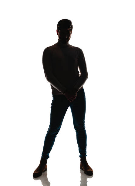 Attractive young male model posing in black pants and black sweater