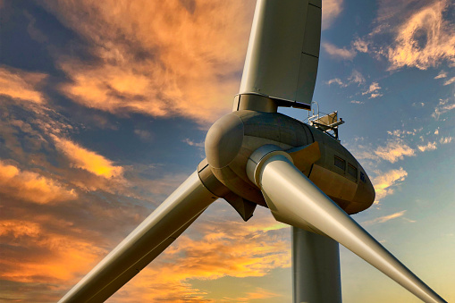 Wind energy generator turbines at sunset