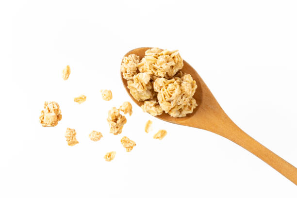 istock granola pieces on spoon isolated on white background 1371945982