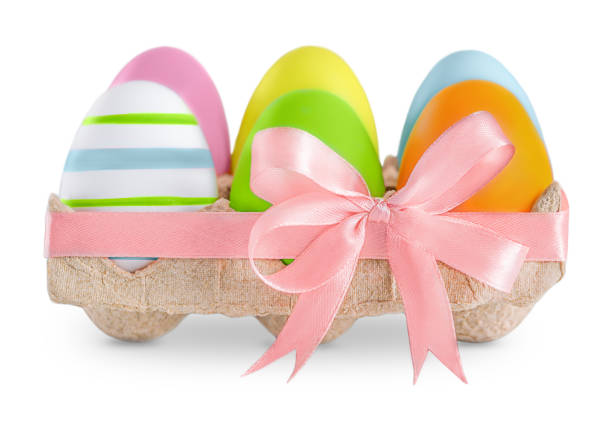 painted Easter eggs in a paper container with a ribbon isolated on a white background