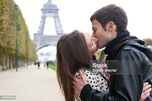 Young Romantic Couple Kissing Near The Eiffel Tower In Paris Stock Photo - Download Image Now