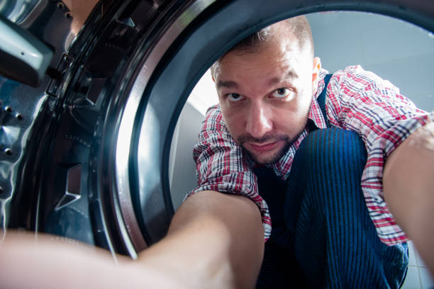 istock Handyman Repairing Washing Machine 1371949628