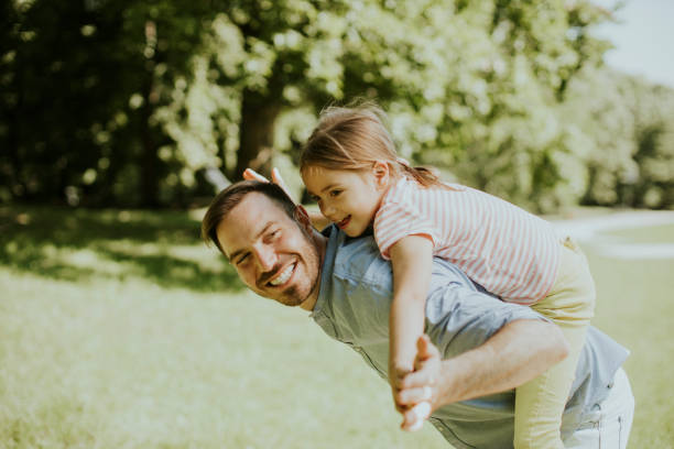 istock Father with daughter having fun at the park 1371949922