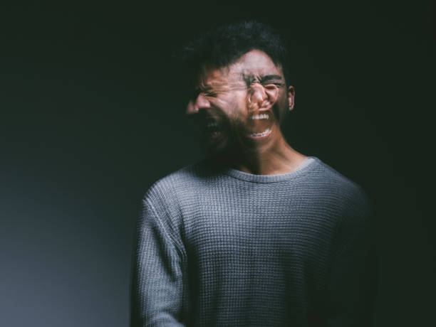 Studio shot of a young man experiencing mental anguish and screaming against a black background Your thoughts can make you or break you insanity stock pictures, royalty-free photos & images