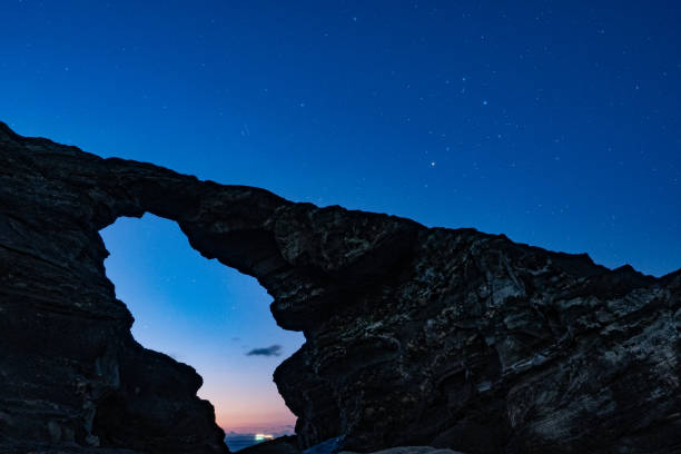 istock Scorpio and dawn shining on strange rocks 1371951834