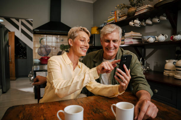 istock Caucasian senior couple looking at cellular device 1371953205