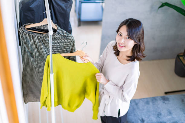 istock Young woman choosing clothes at home 1371954239