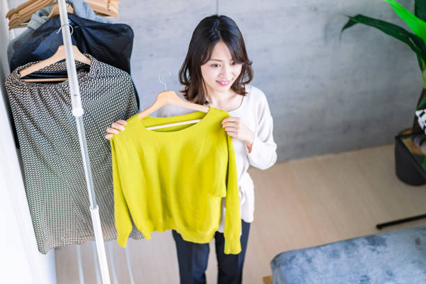 istock Young woman choosing clothes at home 1371954252
