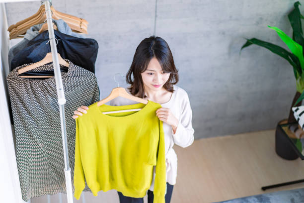istock Young woman choosing clothes at home 1371954253