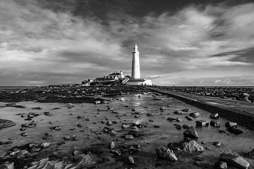 Fraserburgh harbour lighthouse in black & white taken as a storm was brewing with dark black clouds.