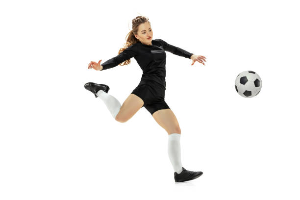 kopnięcie nogą. jedna sportowa dziewczyna, piłkarka trenująca z piłką nożną odizolowaną na białym tle studyjnym. sport, akcja, ruch, fitness - women human leg men shorts zdjęcia i obrazy z banku zdjęć