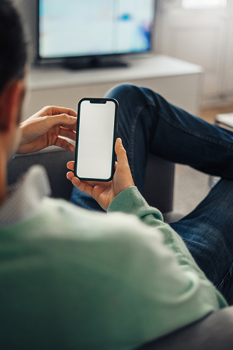 Man using cellphone at home