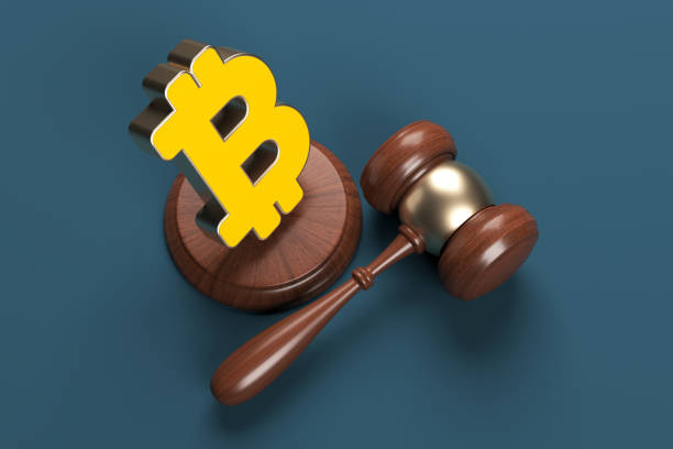 Orange-colored bitcoin symbol and judgment mallet. stock photo