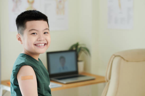istock Happy boy sitting at doctors office 1371958774