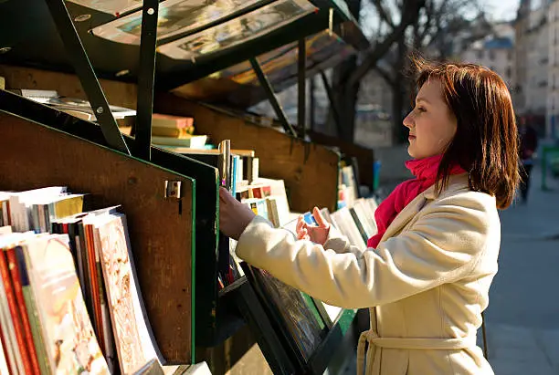 Photo of Beautiful woman in Paris selecting a book