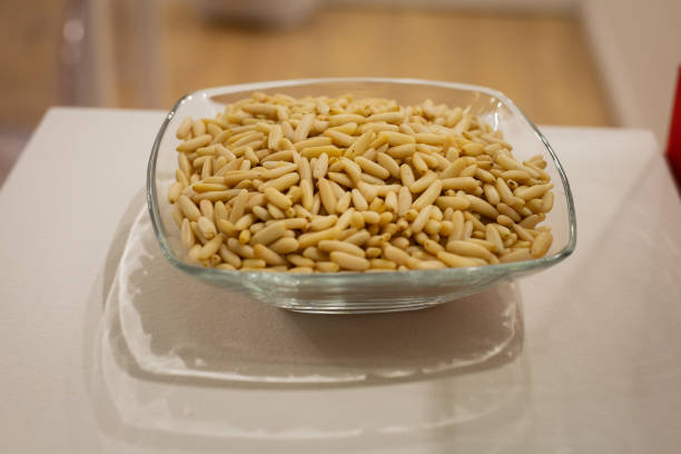 Transparent Glass Container Full of Pine Nuts.