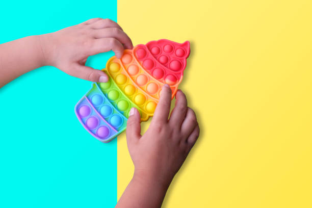istock children playing with pop it fidget toys close up 1371960436