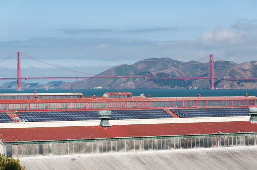 The historic converted buildings of Fort Mason with the golden gate bridge in the background on san Francisco bay on a sunny day in california.