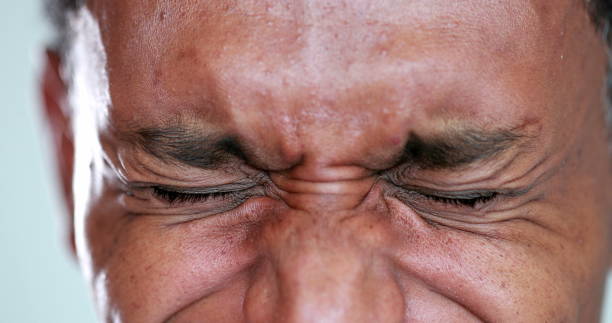 istock African man eyes squinting. Close-up black guy closing eyes squint 1371962814