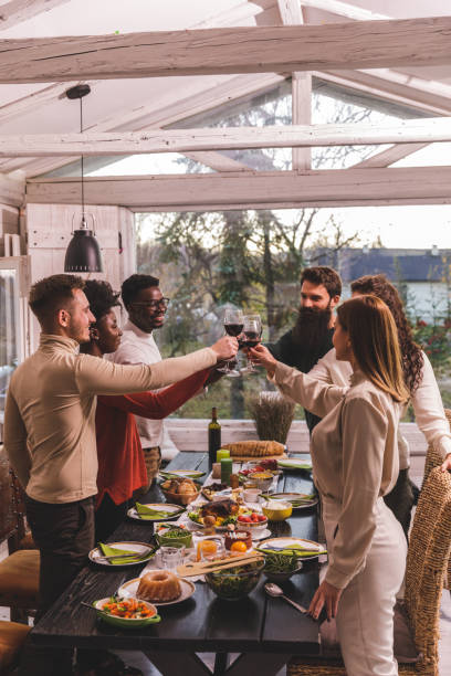 istock Diverse group of friends cheering with red wine before enjoying dinner 1371963155