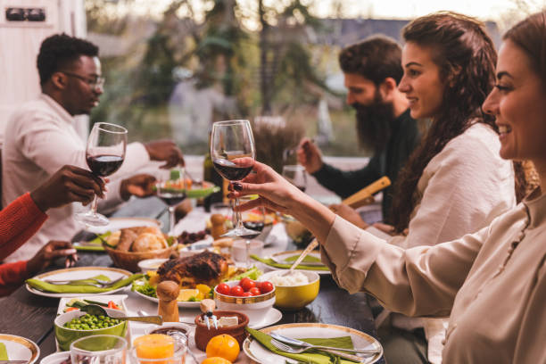 istock Friends making a celebratory toast with red wine during dinner party 1371963156