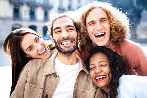 istock Multicultural students taking photo out side with backlight - Happy milenial life style concept on young multiracial college students having fun day together at university yard - Bright warm filter 1371963437