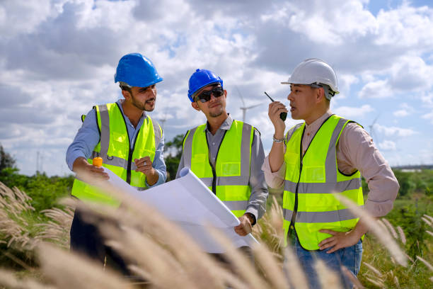 istock Blue collar workers at electricity site. Windmill field. 1371965045
