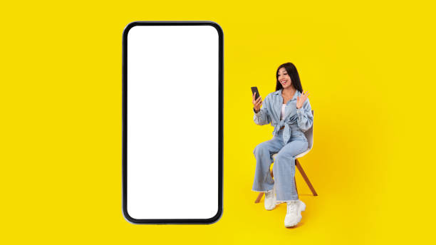 istock Cheerful woman having video call using cellphone and waving 1371965976