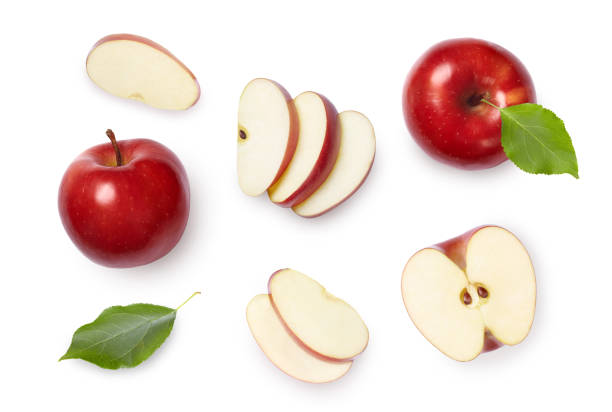 Set of red apples Whole and sliced red apples with green leaves isolated on white background. Top view. chopped food stock pictures, royalty-free photos & images