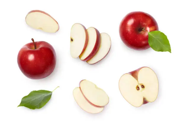 Whole and sliced red apples with green leaves isolated on white background. Top view.