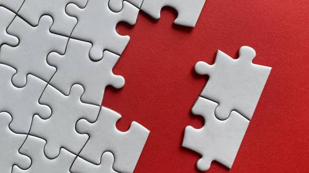 istock Top view of missing jigsaw puzzle with red color background. 1371970587