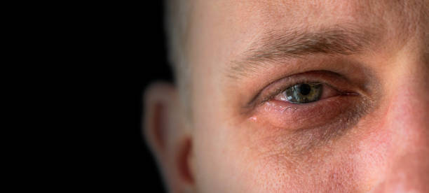 sad man on black background Close-up of a watery man's eye man crying stock pictures, royalty-free photos & images