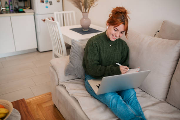 istock Young Caucasian woman using a laptop at home 1371972270