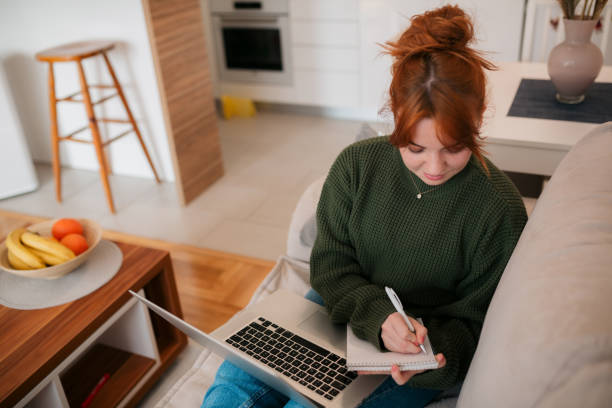istock Young Caucasian woman using a laptop at home 1371972274